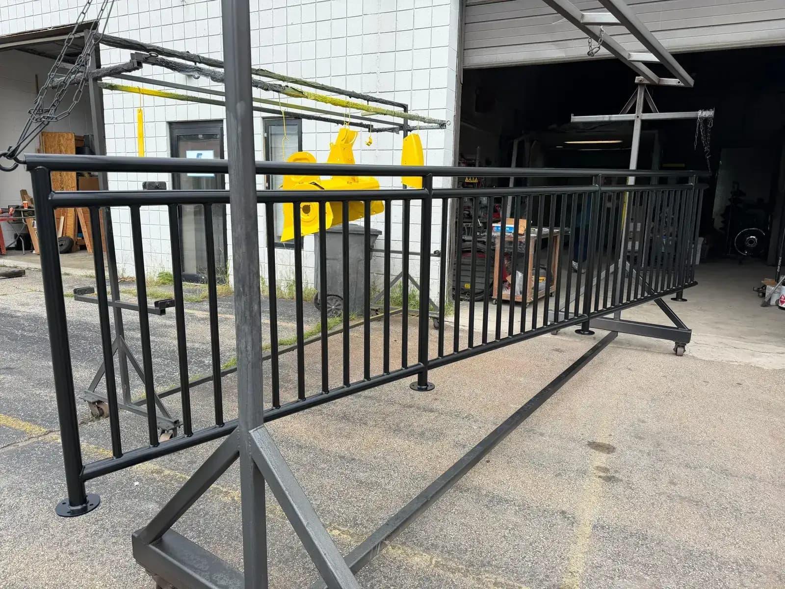 Black powder coated railing section on a rack