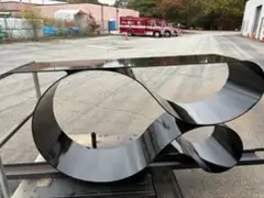 Curved steel panels powder coated in black