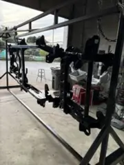 Black powder coated truck parts hanging on a rack