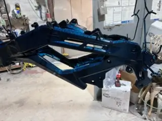 Industrial equipment arm powder coated in blue