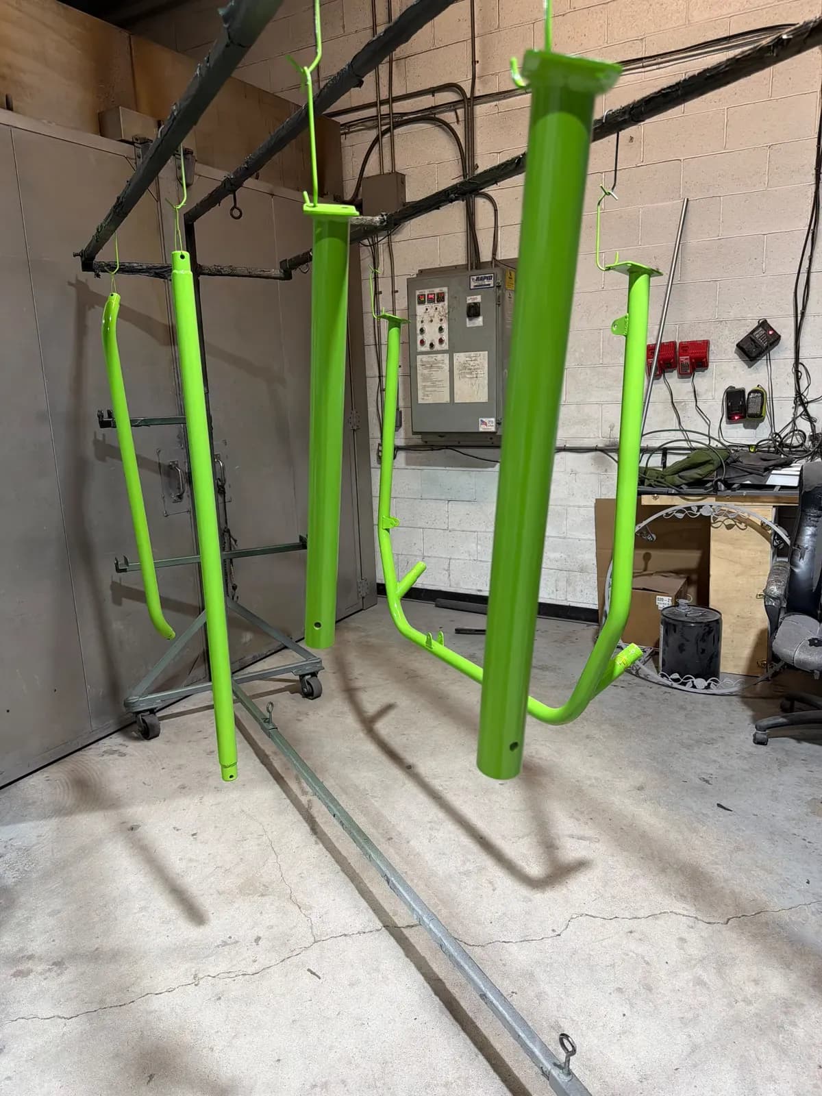 Steel posts powder coated in lime green inside the shop