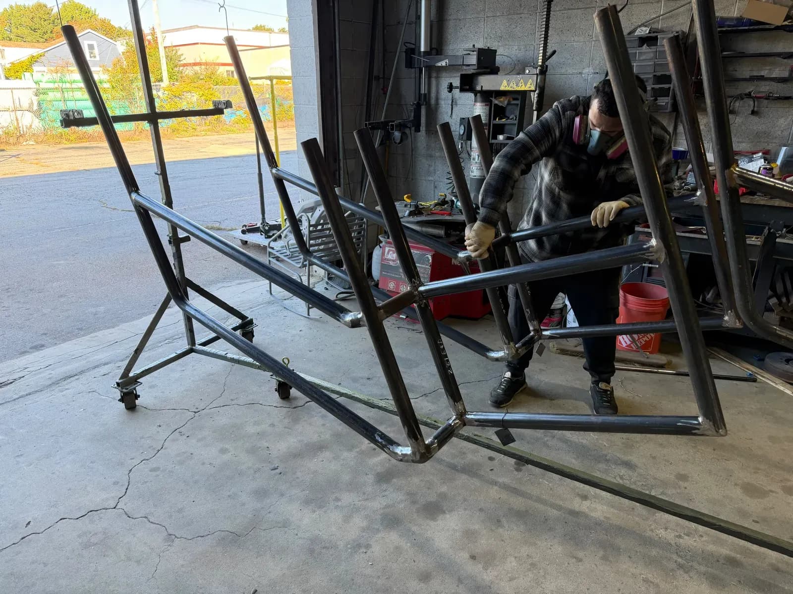 Shop crew hanging metal frames before coating