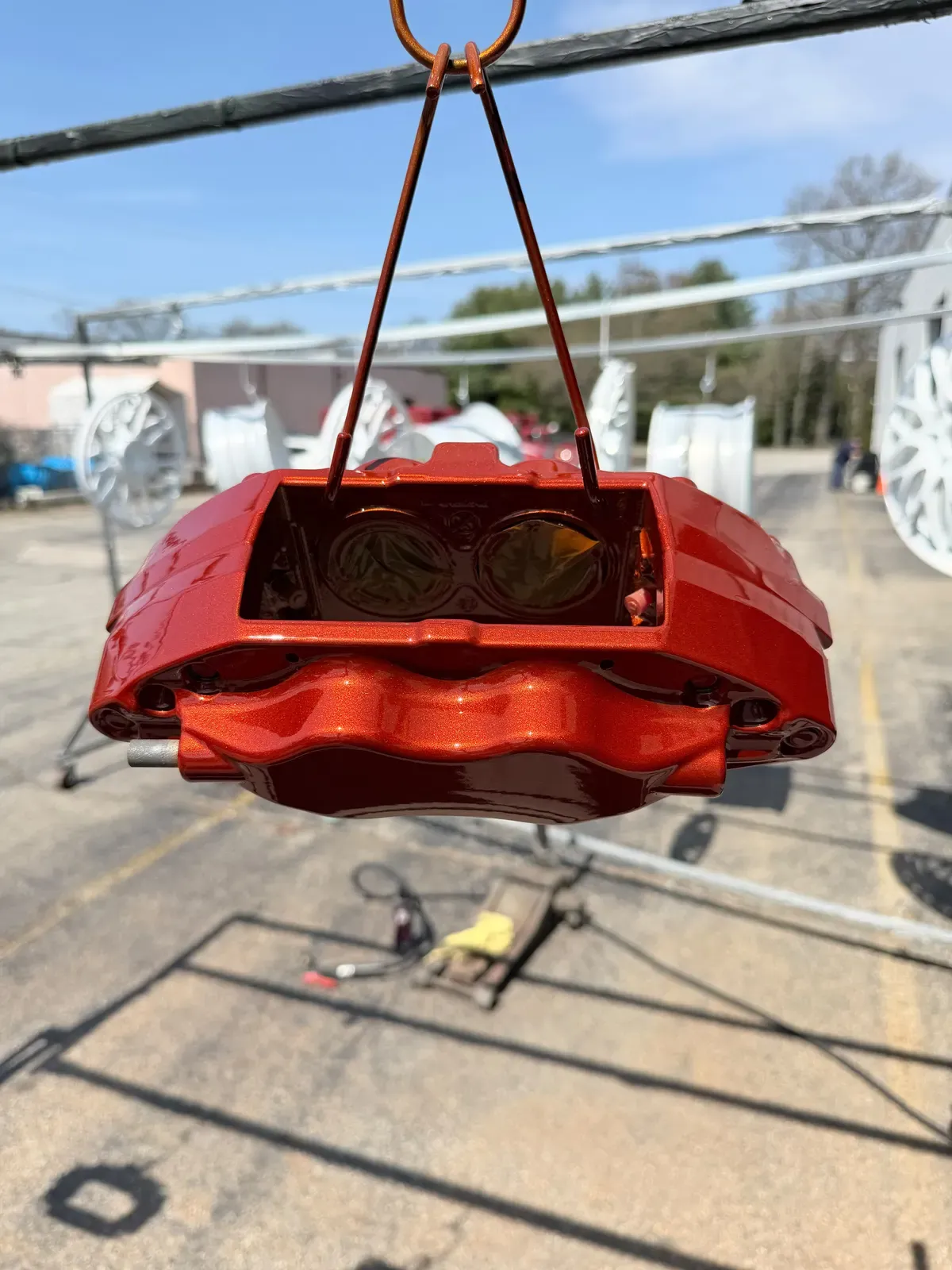 Red brake caliper on the curing rack