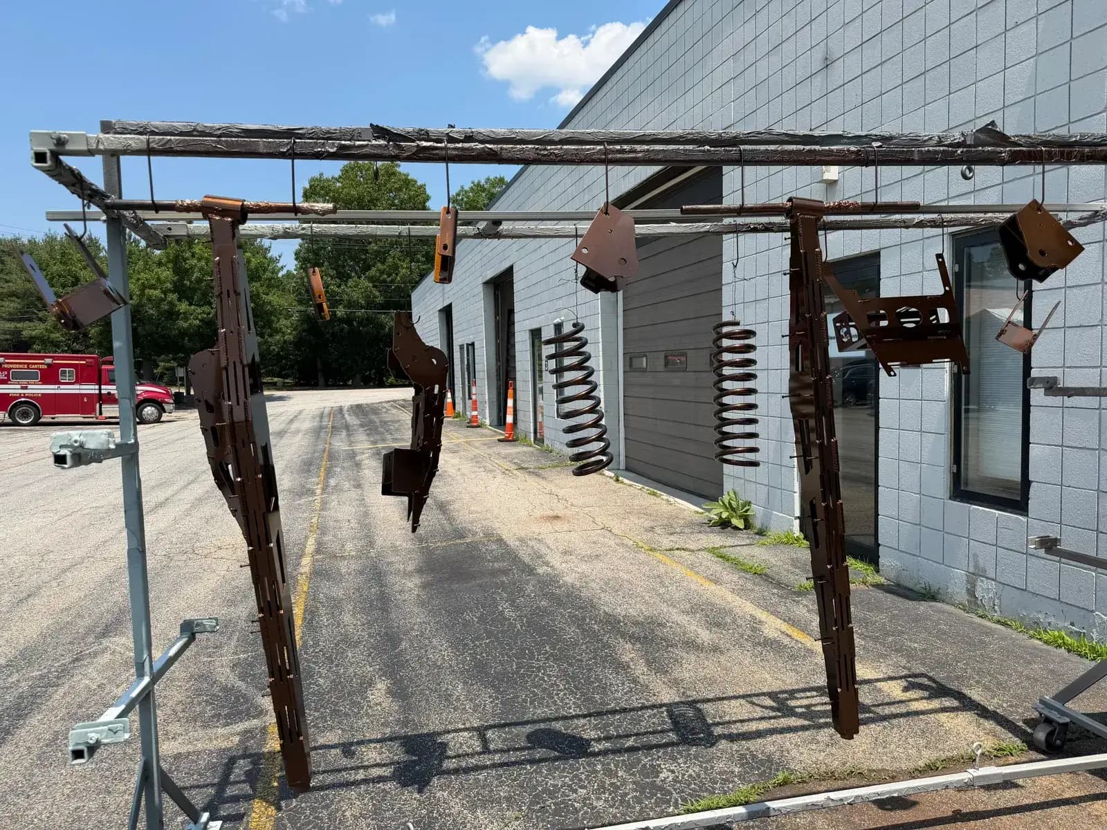 Rusty truck parts hanging before sandblasting
