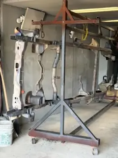 Truck frame parts on a rack after sandblasting
