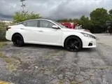 White sedan with black powder coated wheels