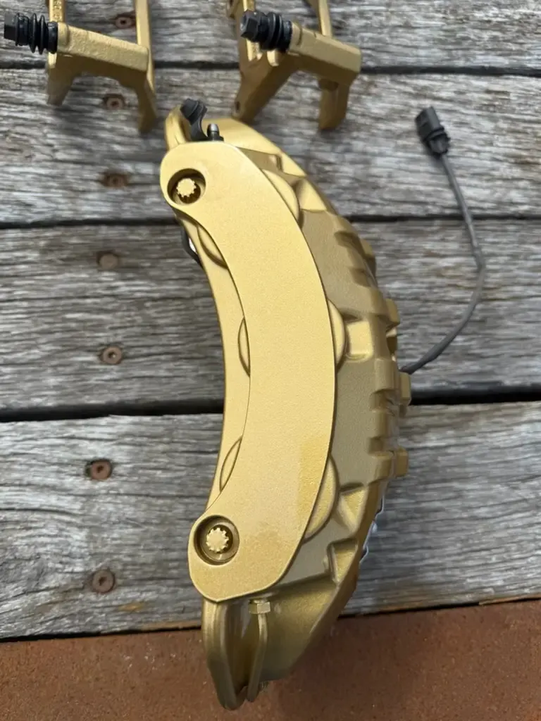 Large brake caliper powder coated in gold